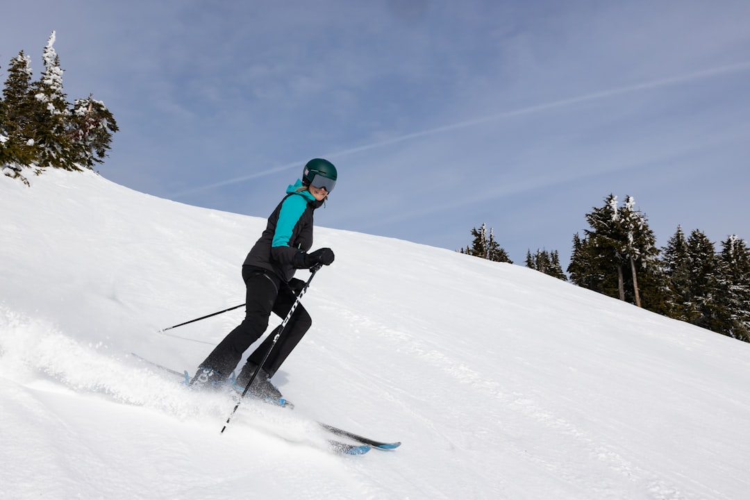 Home female skier turning and spraying snow