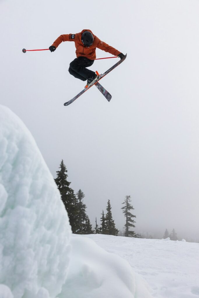 person freestyling ski jumping in the snow